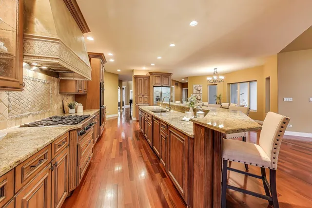 a kitchen with stainless steel appliances granite countertop a stove and a sink