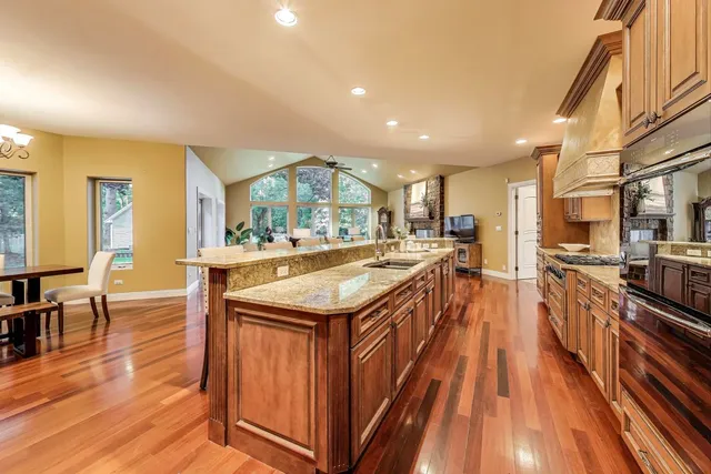 a large kitchen with kitchen island a large island in the center