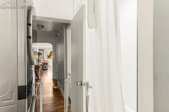 a view of a hallway with wooden floor