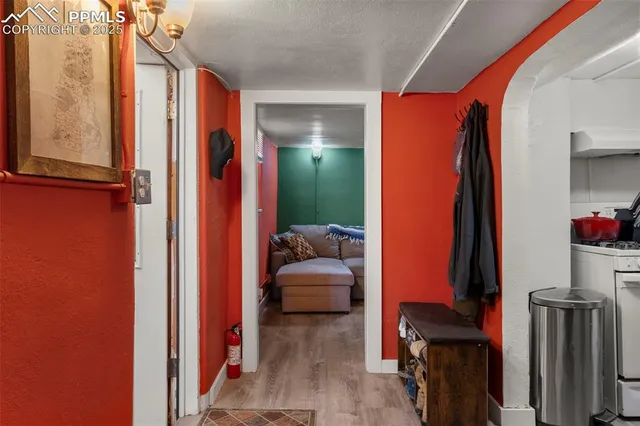 a view of hallway with furniture and a lamp