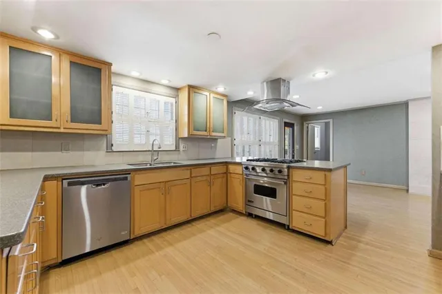 a large kitchen with stainless steel appliances granite countertop a stove and a sink