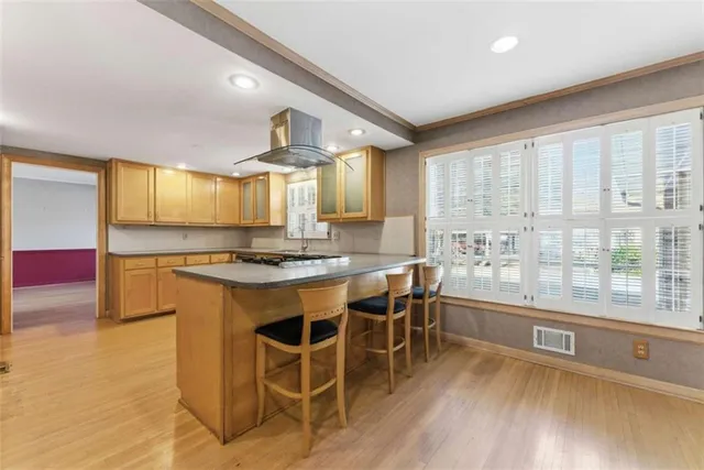 a kitchen with a sink cabinets and wooden floor