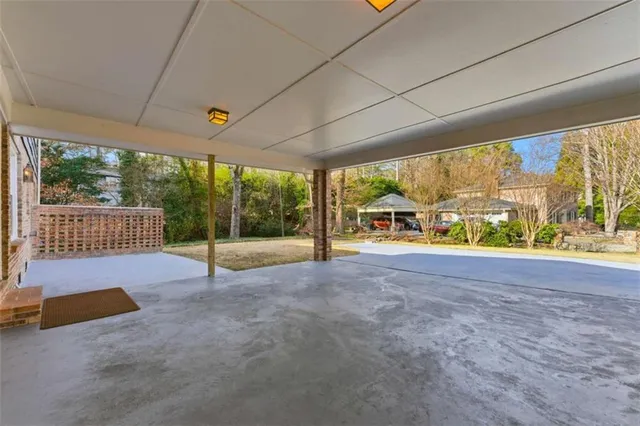 a view of a house with backyard and a tree