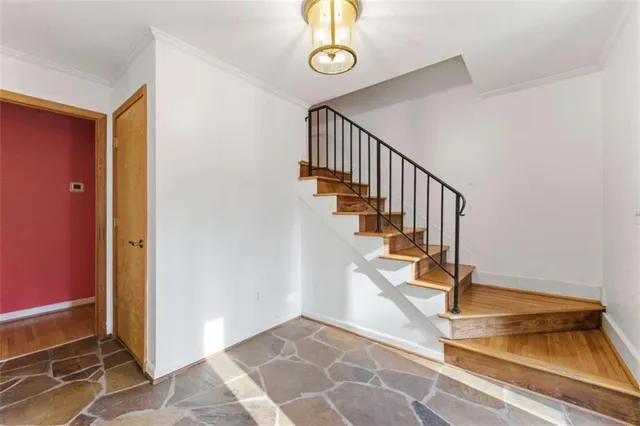 a view of entryway and hall with wooden floor