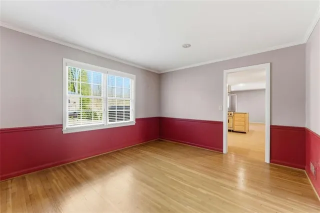 a living room with hardwood floor and a window