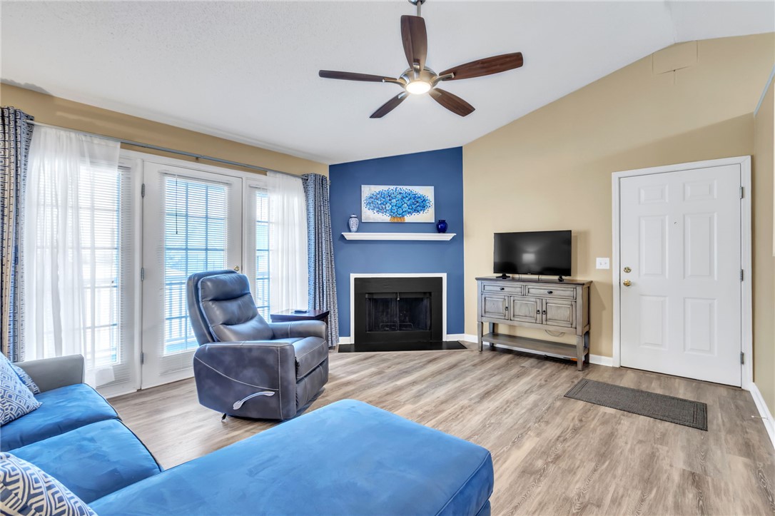 706 Pelham Square Way Greer, SC 29650 - Photo 4 of 20 This inviting living space features warm flooring, a fireplace, and elegant ceiling fan.