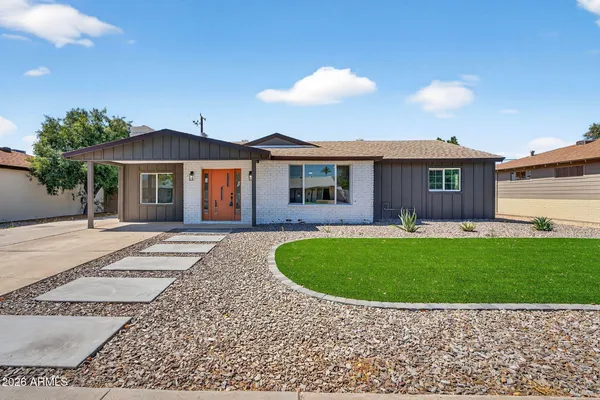 a front view of a house with a garden
