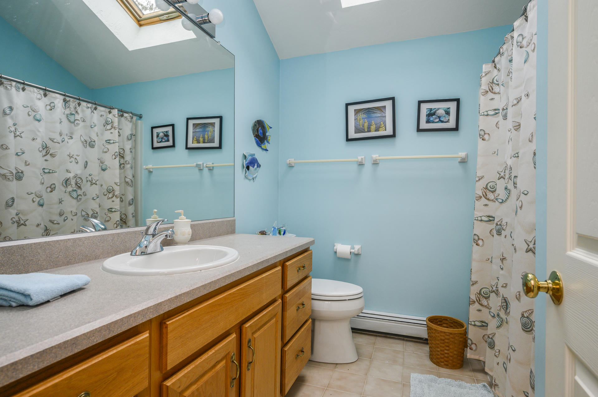 85 Beach Road Orleans, MA 02653 - Photo 11 of 26 a bathroom with a granite countertop sink a toilet and a mirror