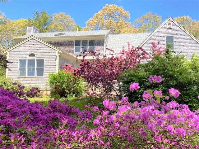 85 Beach Road Orleans, MA 02653 - Photo 3 of 26 a front view of a house with a yard and fountain in front of it