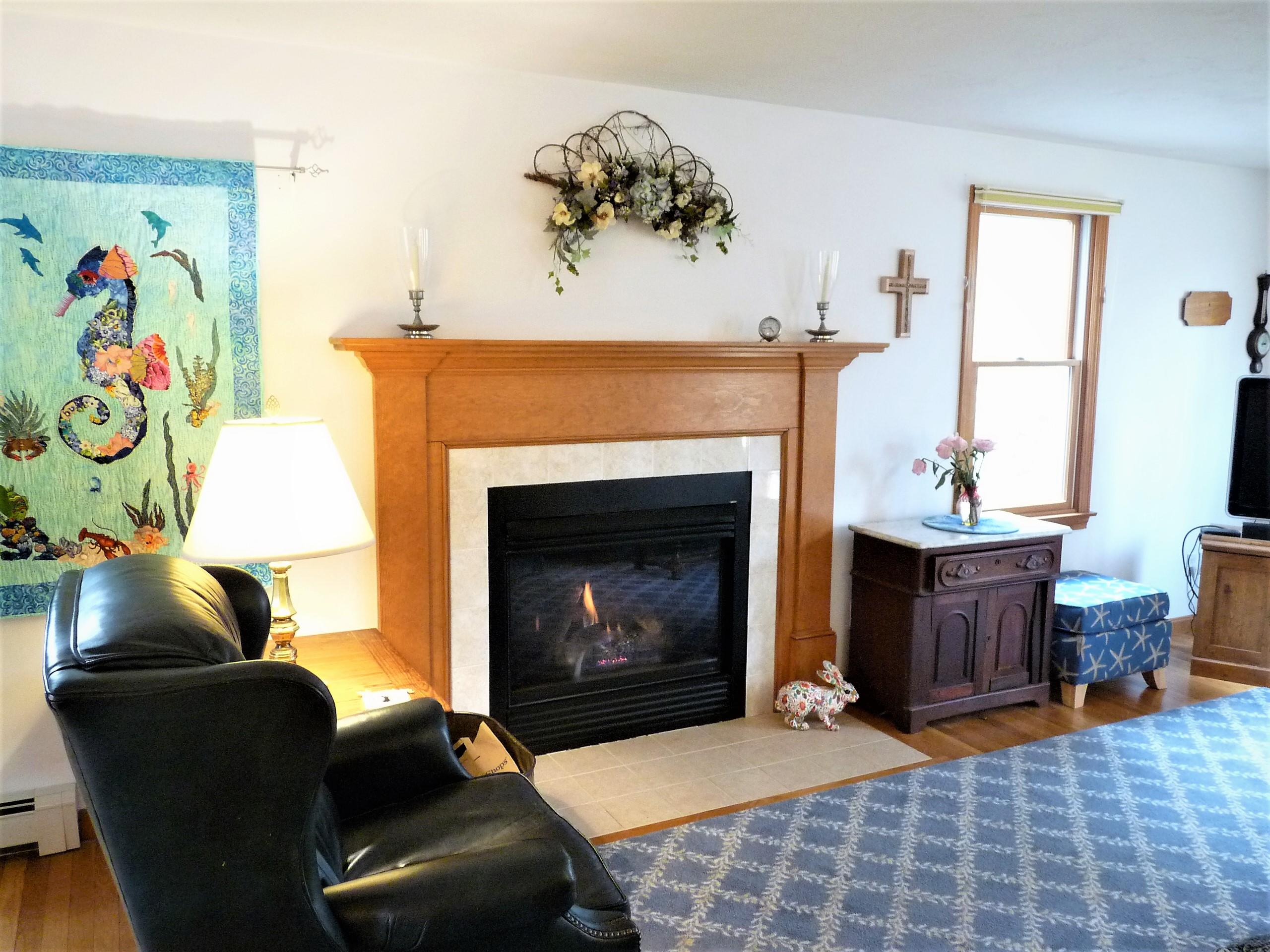 85 Beach Road Orleans, MA 02653 - Photo 5 of 26 a living room with furniture and a fireplace