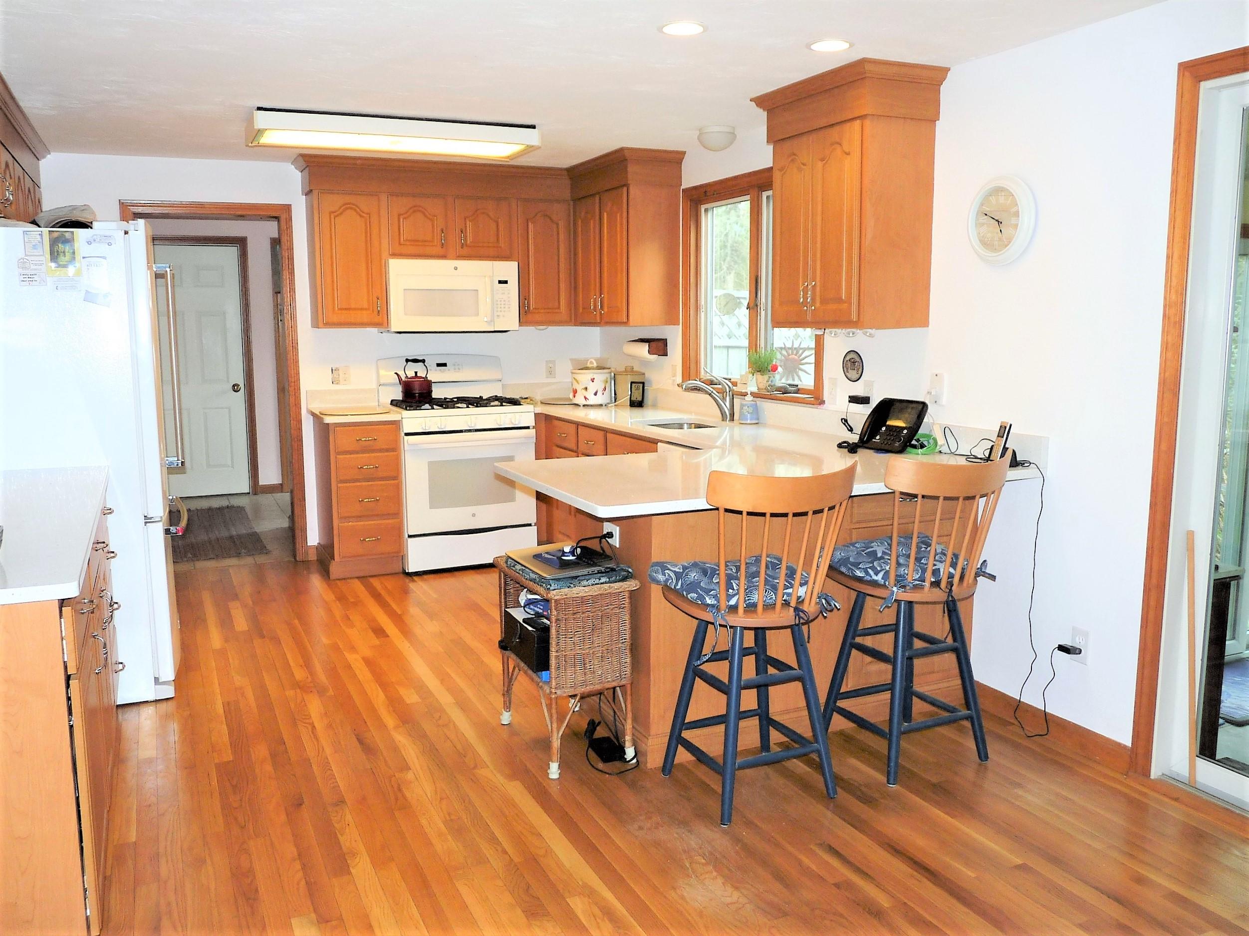 85 Beach Road Orleans, MA 02653 - Photo 6 of 26 a view of a dining room with furniture and wooden floor