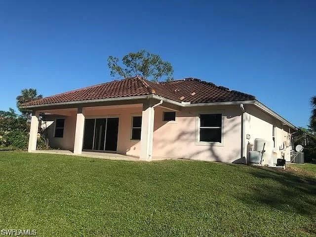 2060 16th Avenue Southwest Naples, FL 34117 - Photo 11 of 13 a front view of a house with a yard
