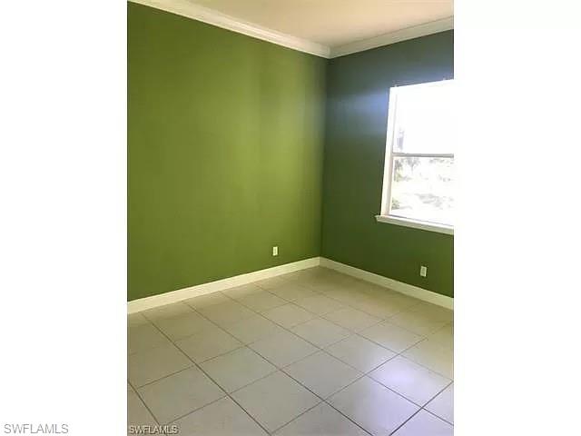 2060 16th Avenue Southwest Naples, FL 34117 - Photo 7 of 13 a view of an empty room with a window