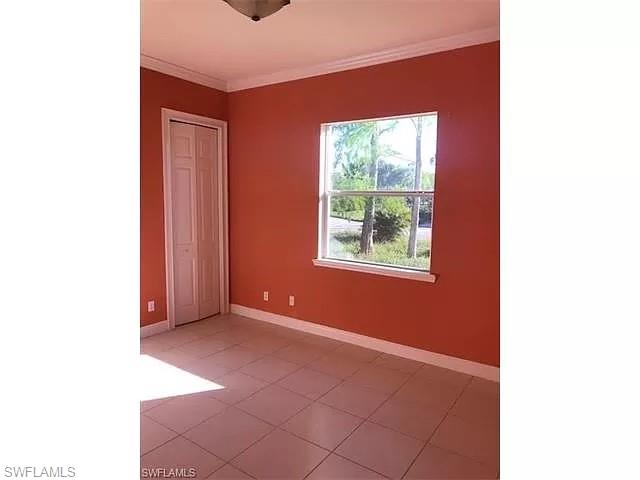 2060 16th Avenue Southwest Naples, FL 34117 - Photo 8 of 13 a view of an empty room with a window