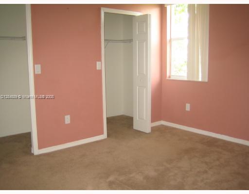 27510 Southwest 138th Path Homestead, FL 33032 - Photo 4 of 11 an empty room with windows