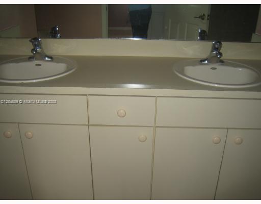 27510 Southwest 138th Path Homestead, FL 33032 - Photo 8 of 11 a bathroom with a sink and a mirror