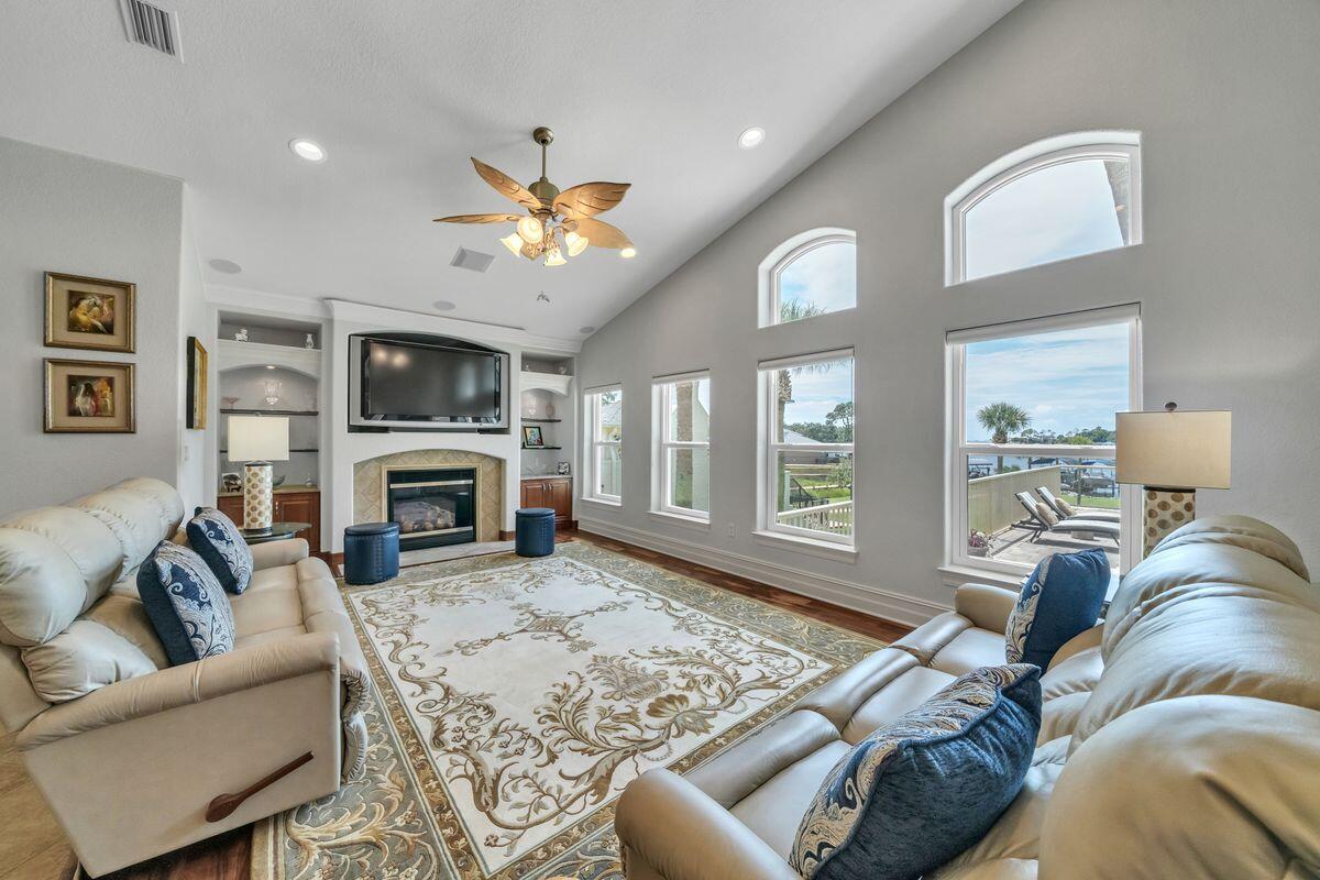 245 Country Club Road Shalimar, FL 32579 - Photo 12 of 46 a living room with furniture a fireplace and a flat screen tv