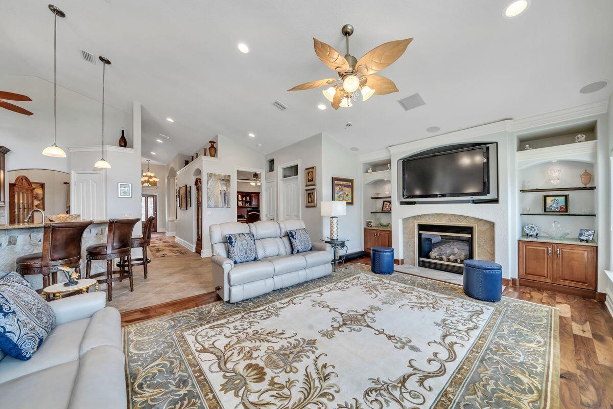 245 Country Club Road Shalimar, FL 32579 - Photo 17 of 46 a living room with furniture a fireplace and a flat screen tv