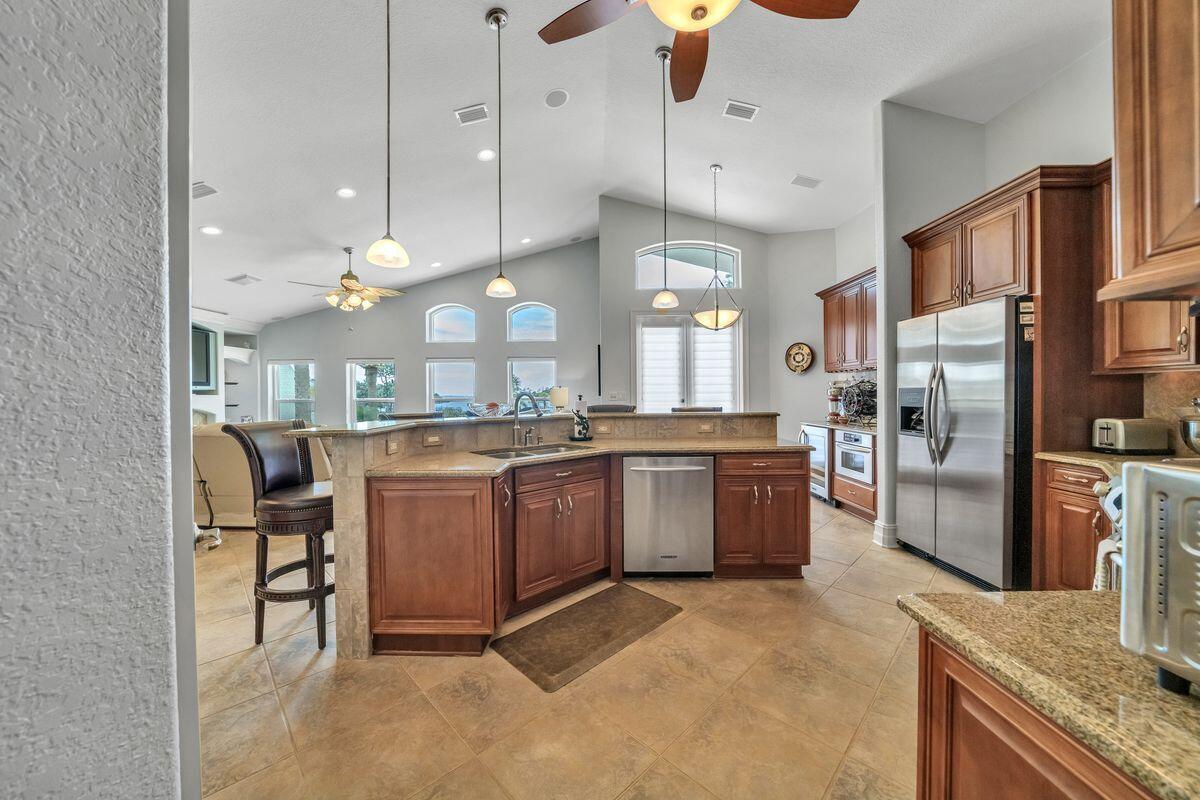 245 Country Club Road Shalimar, FL 32579 - Photo 18 of 46 a kitchen with a refrigerator a sink and a stove