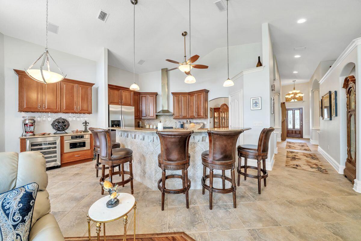 245 Country Club Road Shalimar, FL 32579 - Photo 22 of 46 a kitchen with stainless steel appliances kitchen island granite countertop a table and chairs