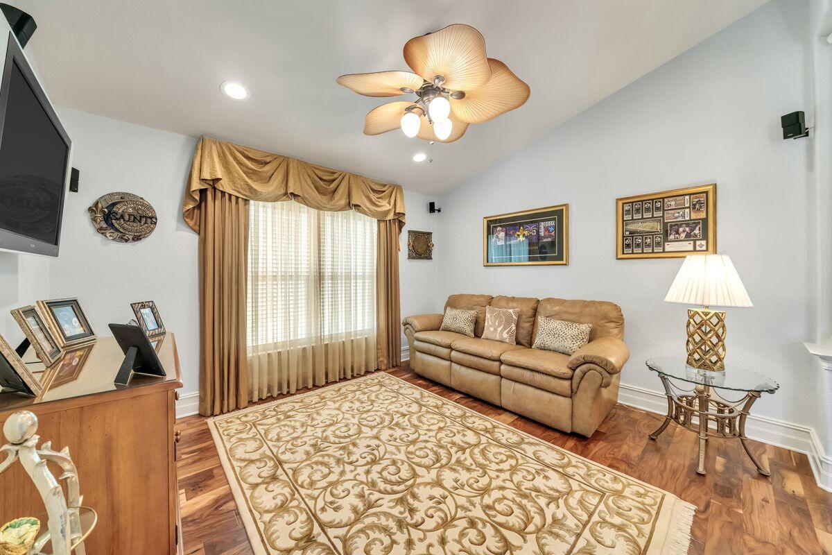 245 Country Club Road Shalimar, FL 32579 - Photo 24 of 46 a living room with furniture and a chandelier