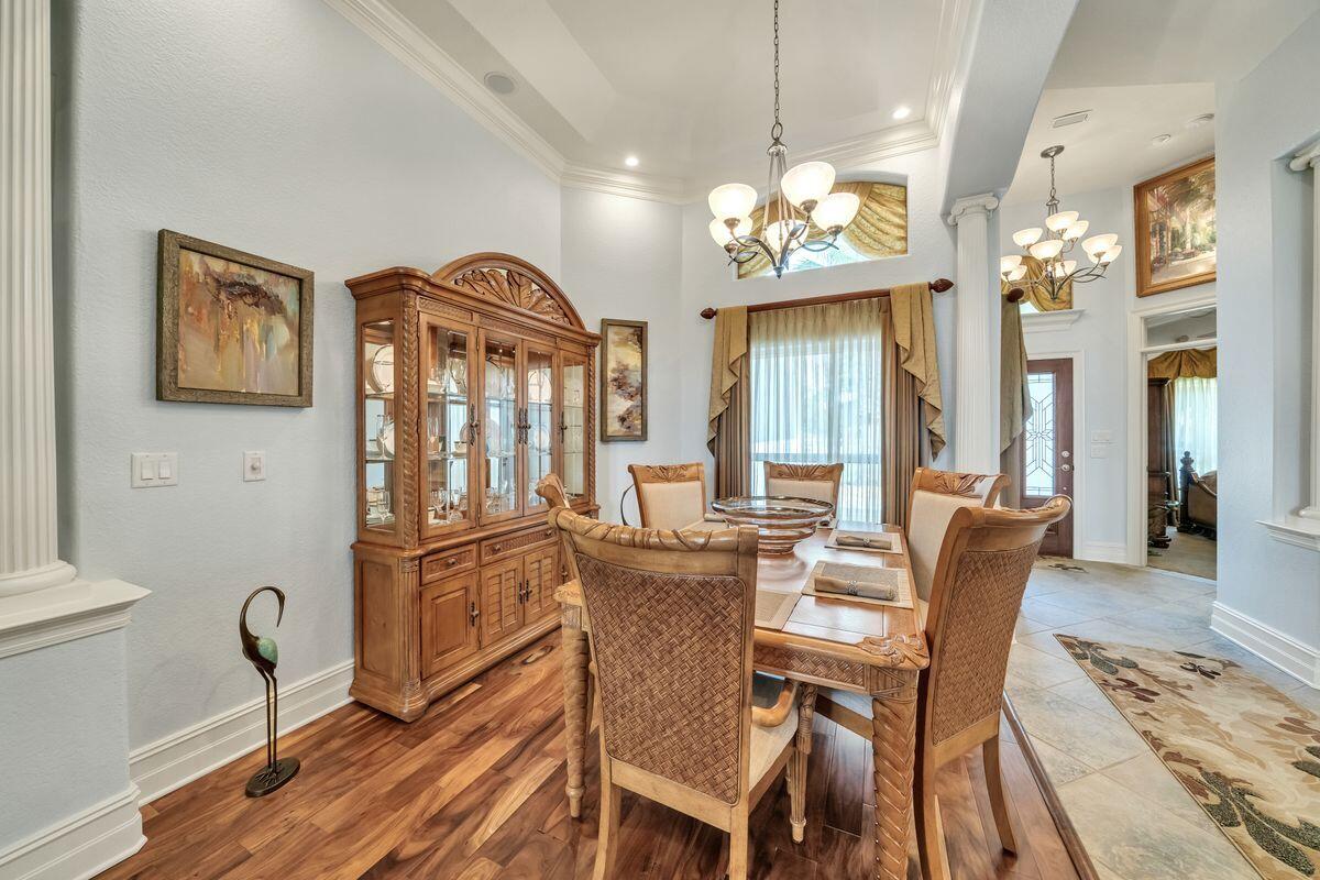 245 Country Club Road Shalimar, FL 32579 - Photo 27 of 46 a view of a dining room with furniture a chandelier and wooden floor
