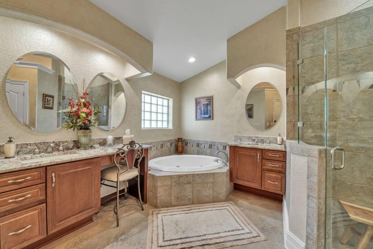 245 Country Club Road Shalimar, FL 32579 - Photo 30 of 46 a spacious bathroom with a granite countertop tub sink and mirror
