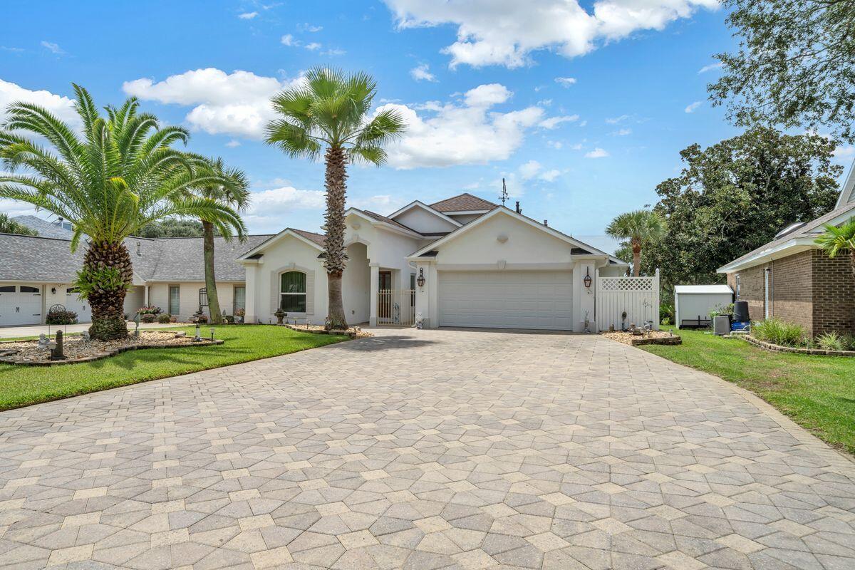 245 Country Club Road Shalimar, FL 32579 - Photo 3 of 46 a front view of a house with a yard and garage