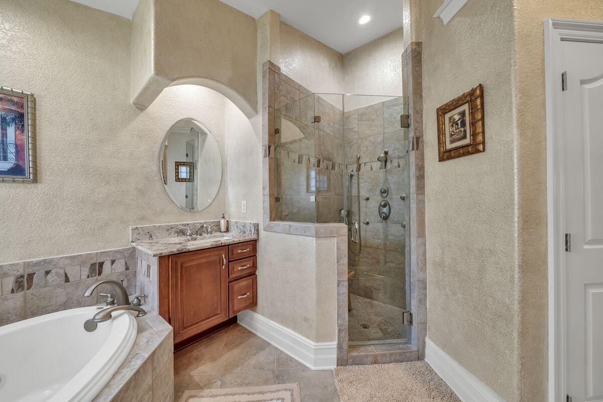 245 Country Club Road Shalimar, FL 32579 - Photo 31 of 46 a spacious bathroom with a tub sink and mirror