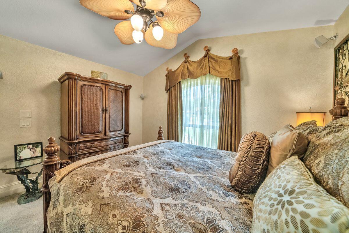 245 Country Club Road Shalimar, FL 32579 - Photo 36 of 46 a bedroom with a bed and a chandelier