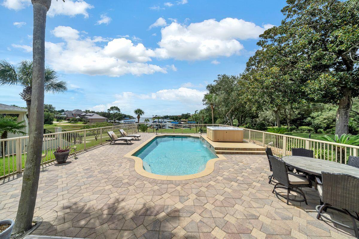 245 Country Club Road Shalimar, FL 32579 - Photo 37 of 46 a view of a swimming pool with a lounge chair