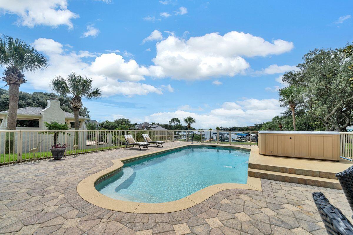 245 Country Club Road Shalimar, FL 32579 - Photo 40 of 46 a view of a swimming pool and lounge chair
