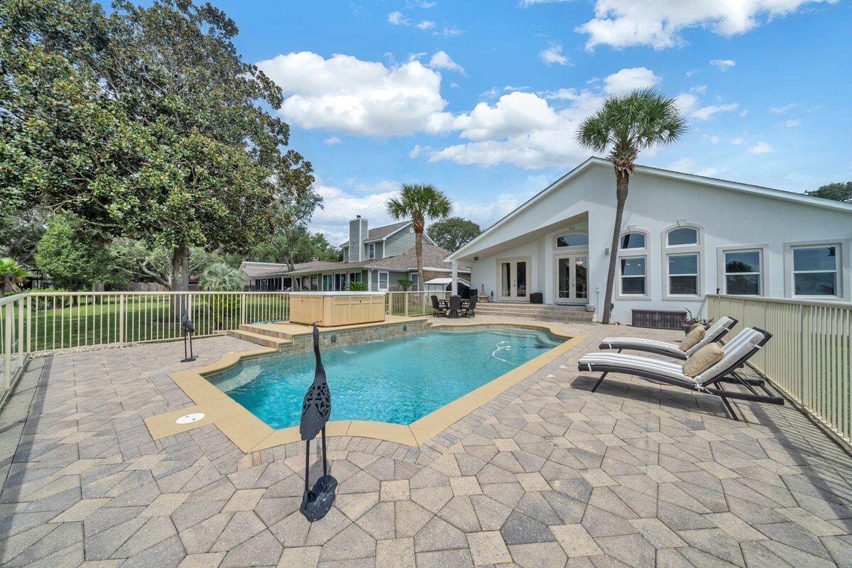245 Country Club Road Shalimar, FL 32579 - Photo 42 of 46 a swimming pool with outdoor seating and plants