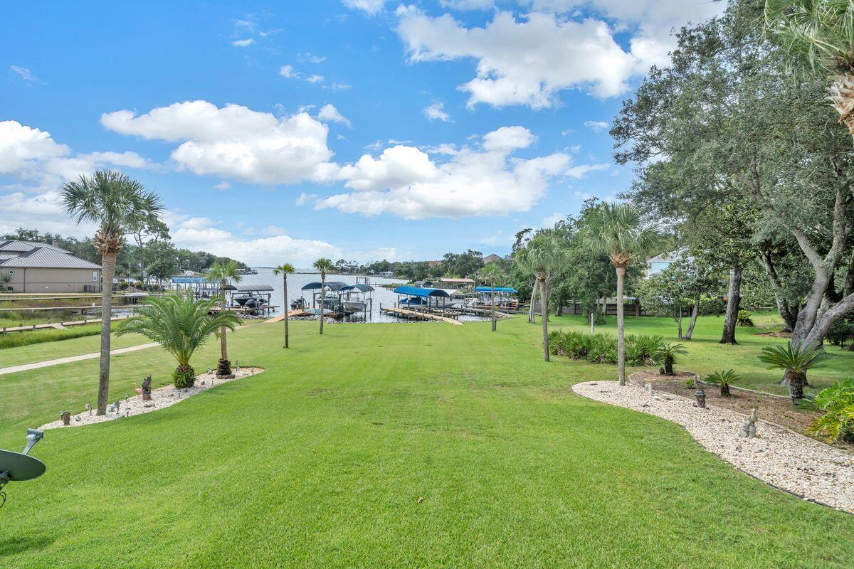 245 Country Club Road Shalimar, FL 32579 - Photo 45 of 46 a view of a golf course with a lake view