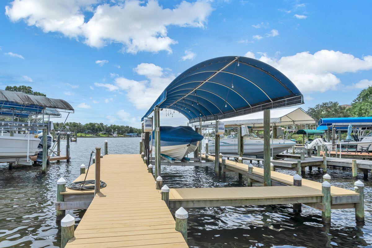 245 Country Club Road Shalimar, FL 32579 - Photo 6 of 46 a view of a patio with table and chairs under an umbrella