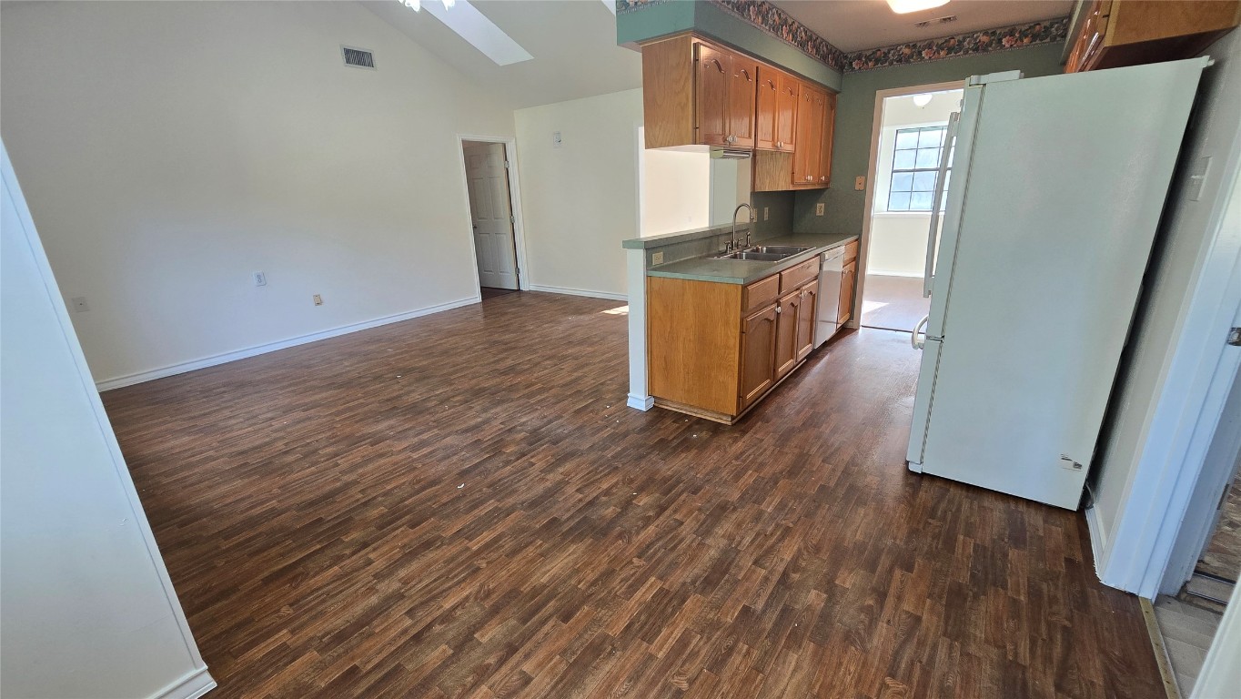 365 Pine Tree Loop Bastrop, TX 78602 - Photo 12 of 22 a kitchen with stainless steel appliances a refrigerator and wooden floor