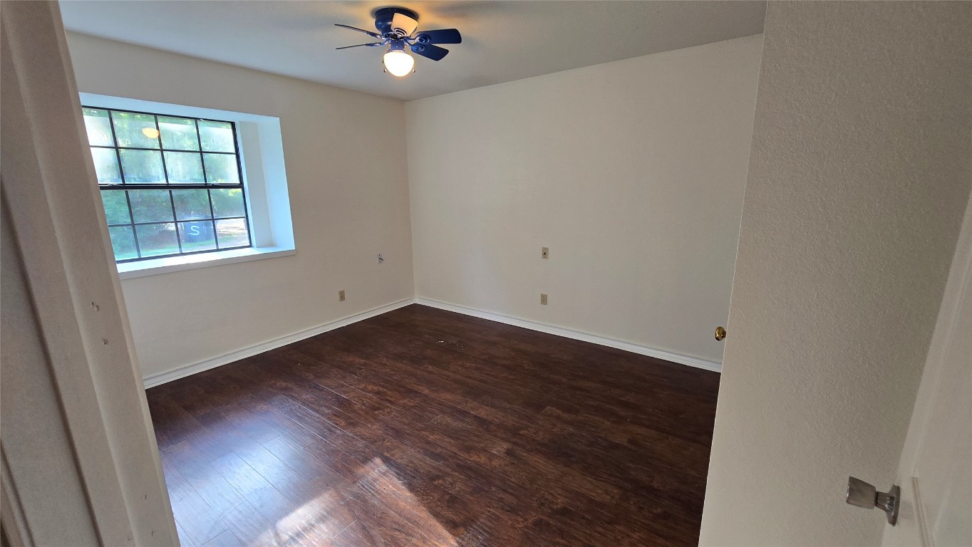 365 Pine Tree Loop Bastrop, TX 78602 - Photo 18 of 22 an empty room with wooden floor and windows
