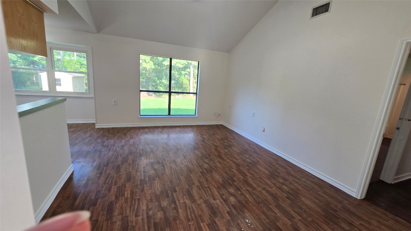 365 Pine Tree Loop Bastrop, TX 78602 - Photo 4 of 22 an empty room with wooden floor and windows