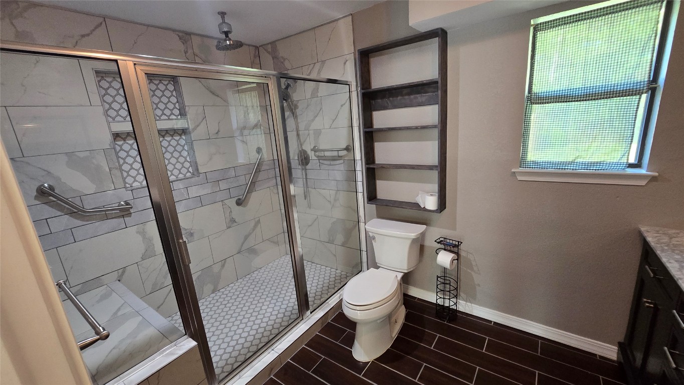 365 Pine Tree Loop Bastrop, TX 78602 - Photo 9 of 22 a bathroom with a toilet and a shower