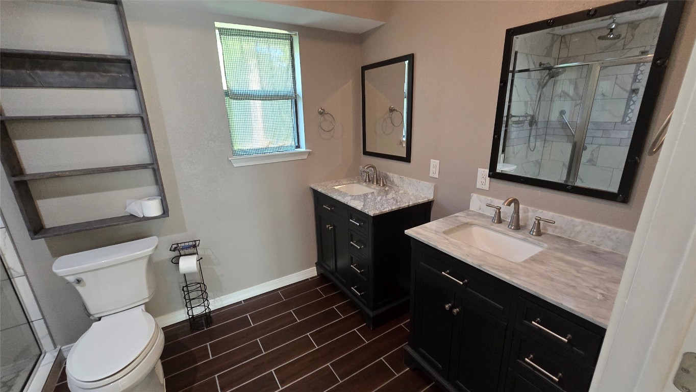 365 Pine Tree Loop Bastrop, TX 78602 - Photo 10 of 22 a bathroom with a granite countertop sink toilet and mirror