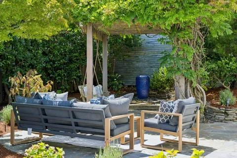a view of a house with a yard and potted plants