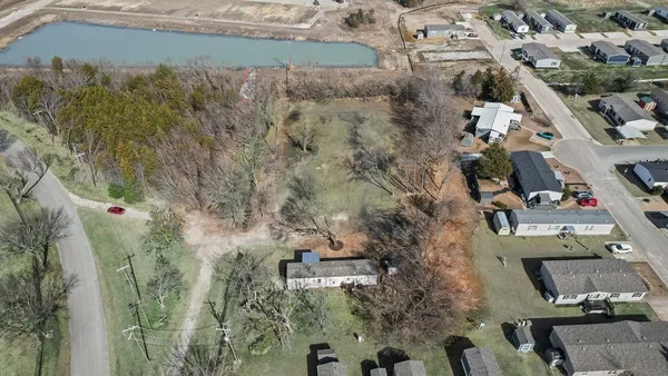 an aerial view of a house with a yard
