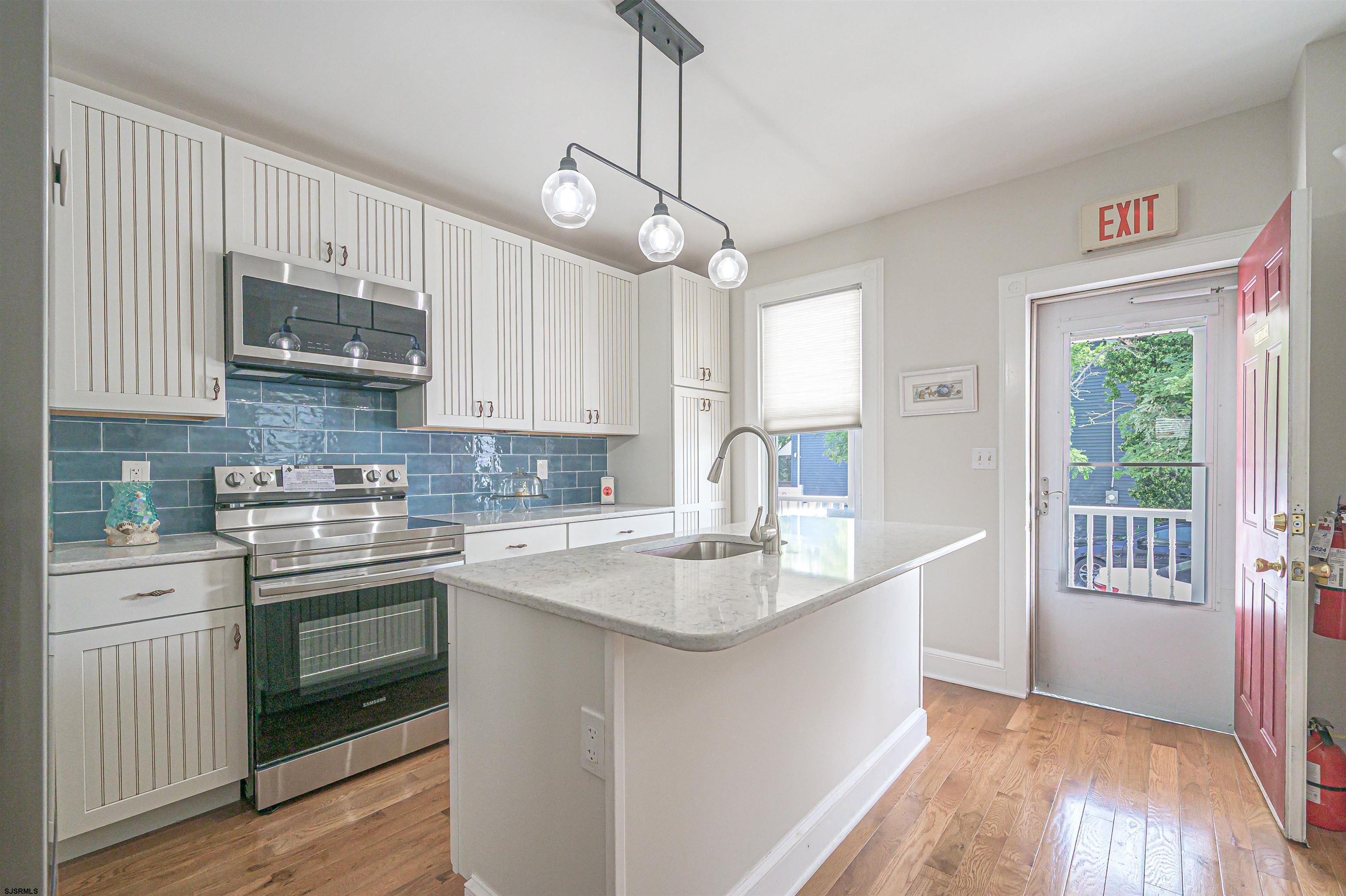 820-822 Shore Somers Point, NJ 08244 - Photo 8 of 27 a kitchen with stainless steel appliances granite countertop a sink stove and refrigerator