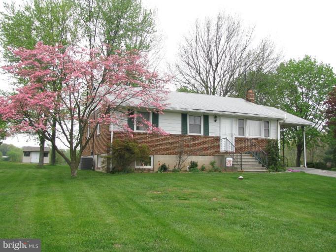 4616 Maple Grove Road Hampstead, MD 21074 - Photo 1 of 15 a front view of a house with a yard and trees