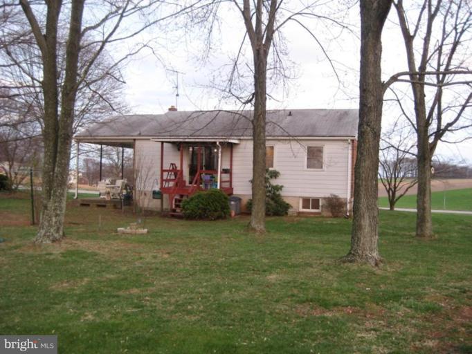 4616 Maple Grove Road Hampstead, MD 21074 - Photo 2 of 15 a front view of a house with garden