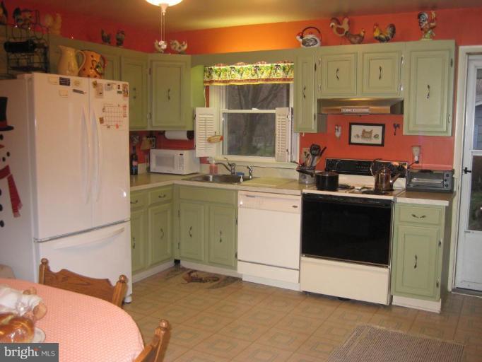 4616 Maple Grove Road Hampstead, MD 21074 - Photo 13 of 15 a kitchen with a stove and a refrigerator