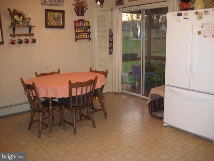 4616 Maple Grove Road Hampstead, MD 21074 - Photo 14 of 15 a dining room with furniture and a large window
