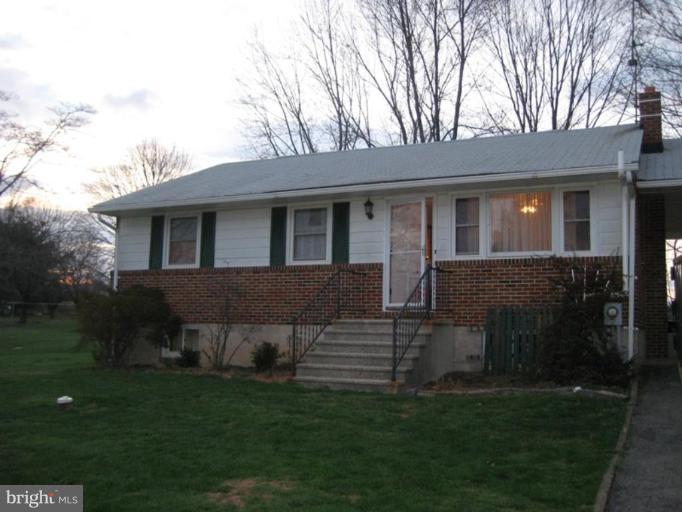 4616 Maple Grove Road Hampstead, MD 21074 - Photo 10 of 15 a front view of a house with a garden