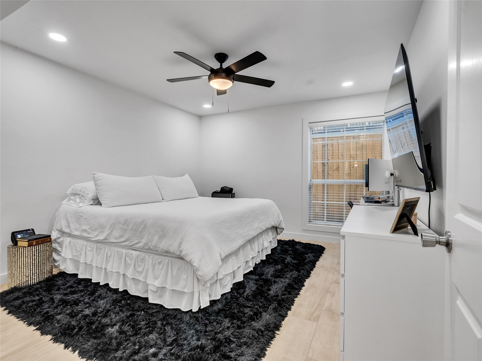 4200 Watson Street, Unit 201 Houston, TX 77009 - Photo 11 of 21 a bedroom with a bed and a large mirror next to a window