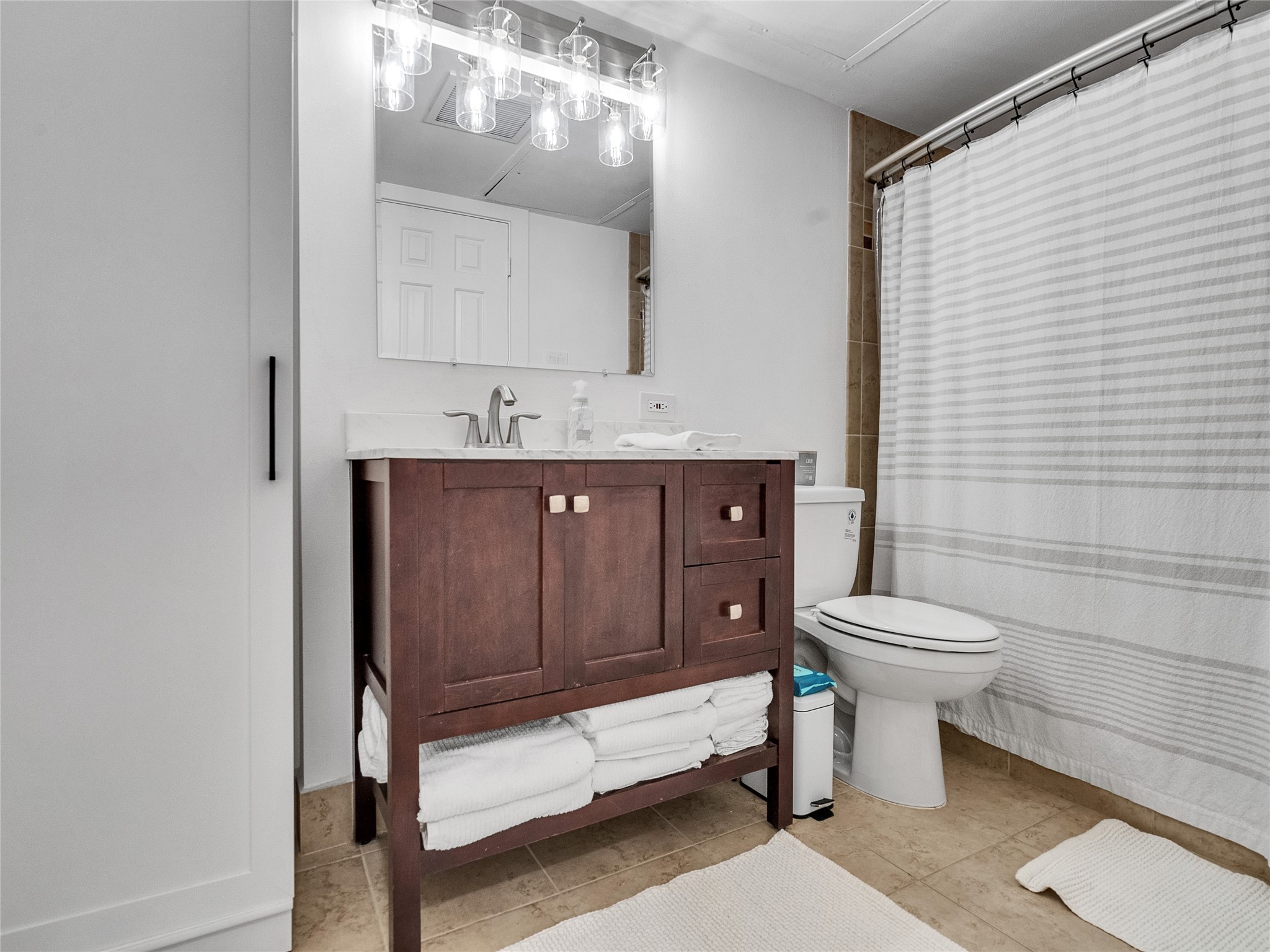 4200 Watson Street, Unit 201 Houston, TX 77009 - Photo 12 of 21 a bathroom with a toilet sink and mirror